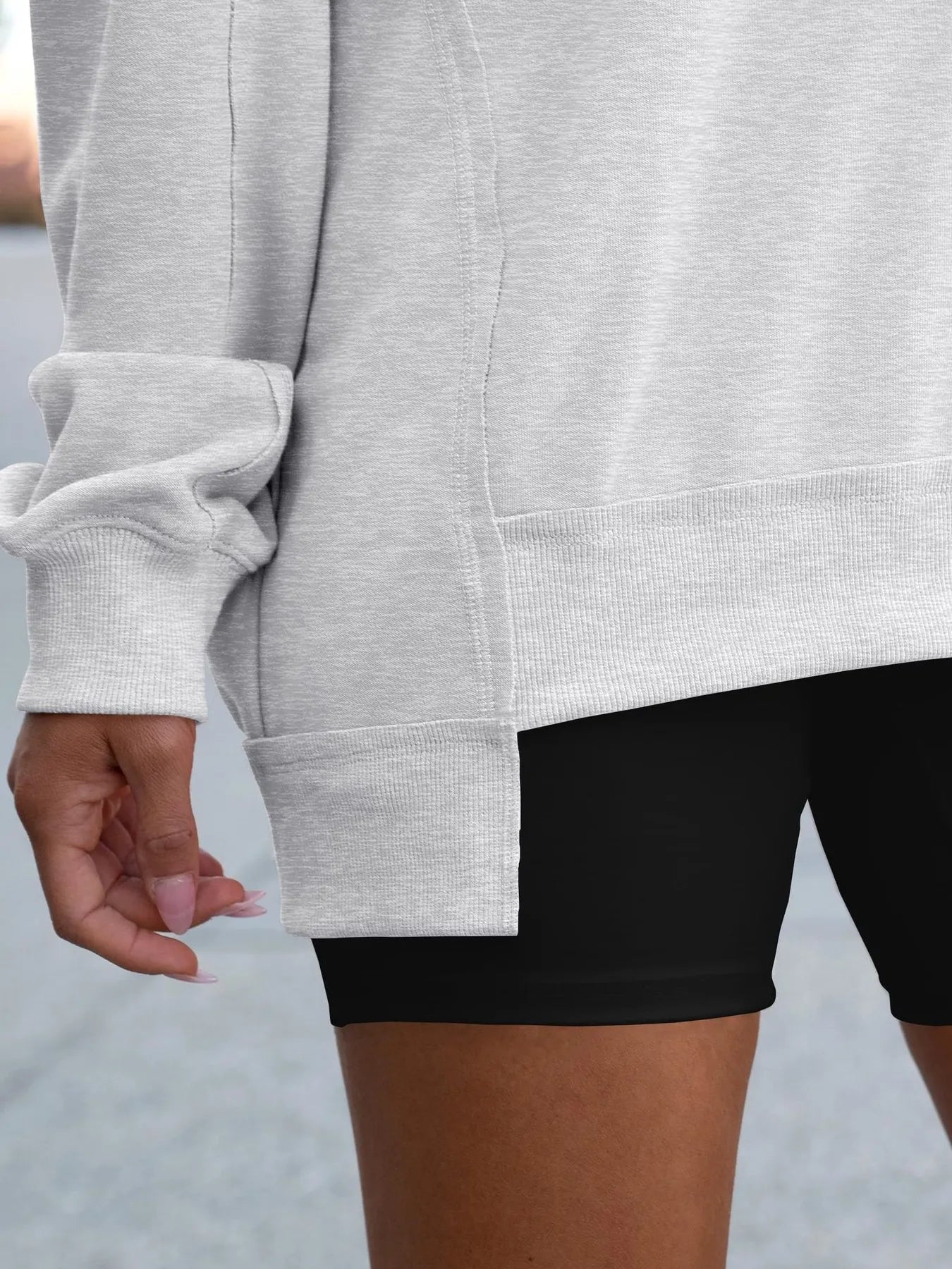 Close up of Notched Long Sleeve Oversized Sweatshirt showing side detail and contrast stitching, perfect for casual wear.
