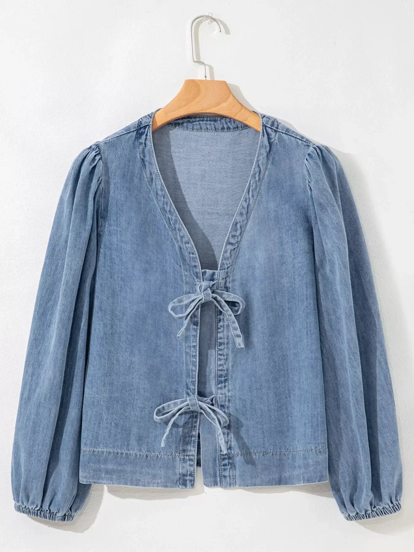 Tied front puff sleeve denim top for women on hanger, stylish jean blouse with casual elegance.