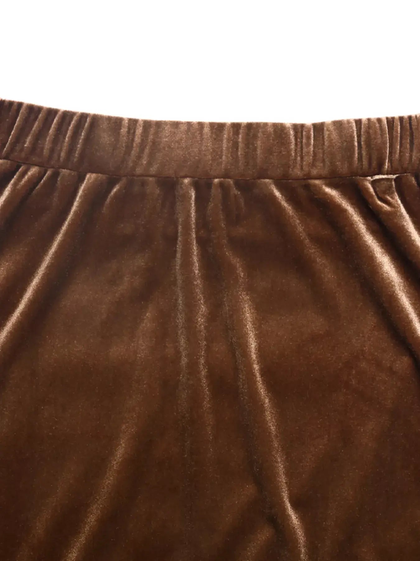 Close-up of the Velvet Tiered Midi Skirt's soft brown velvet fabric and elastic waistband.