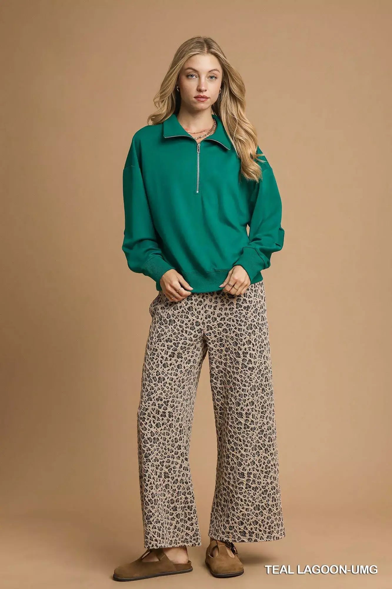 Umgee Half Zip Drop Shoulder Sweatshirt in teal worn with printed wide-leg pants.