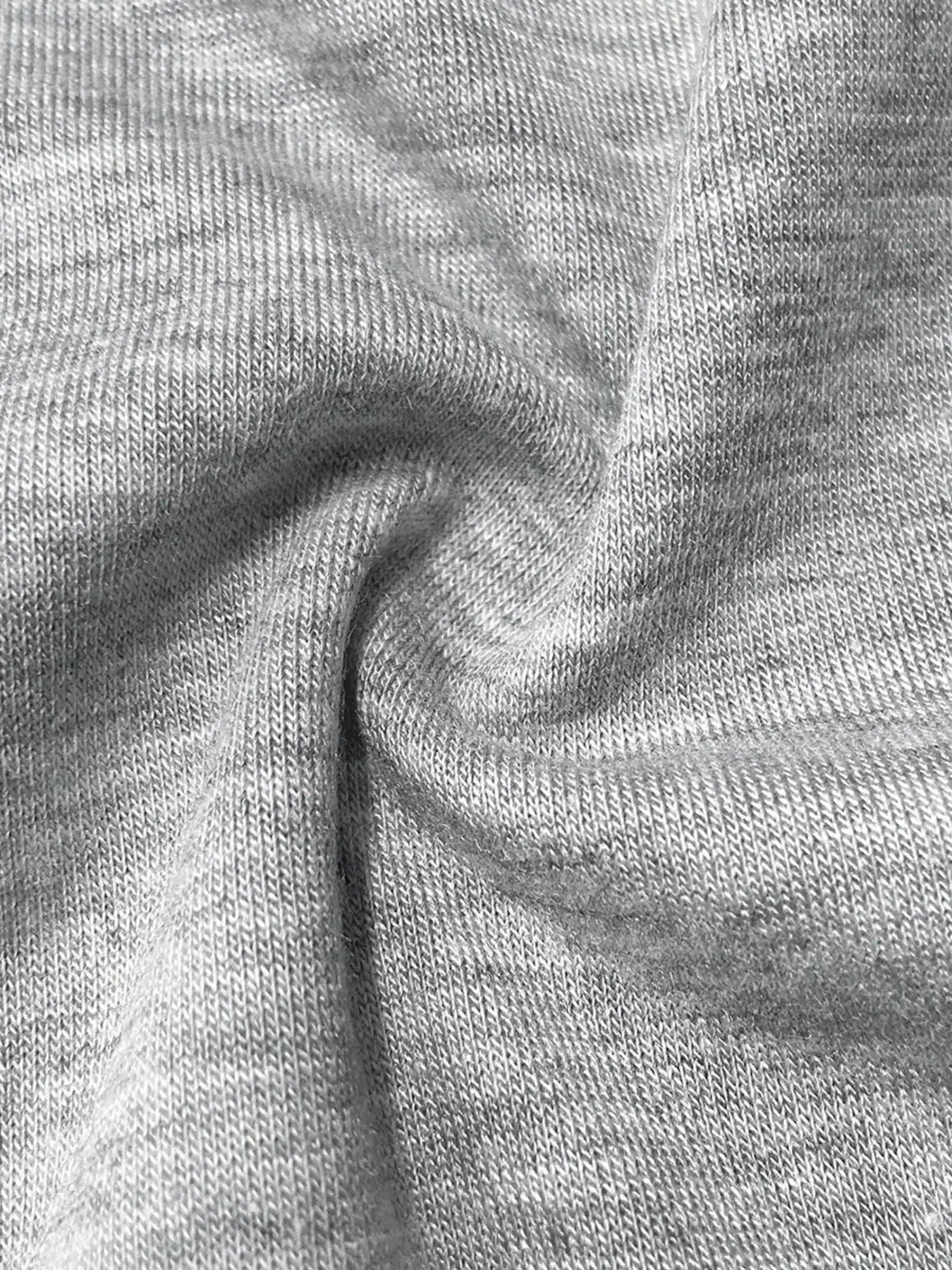 Close-up of soft gray fabric showcasing texture for Long Sleeve Drawstring Romper.