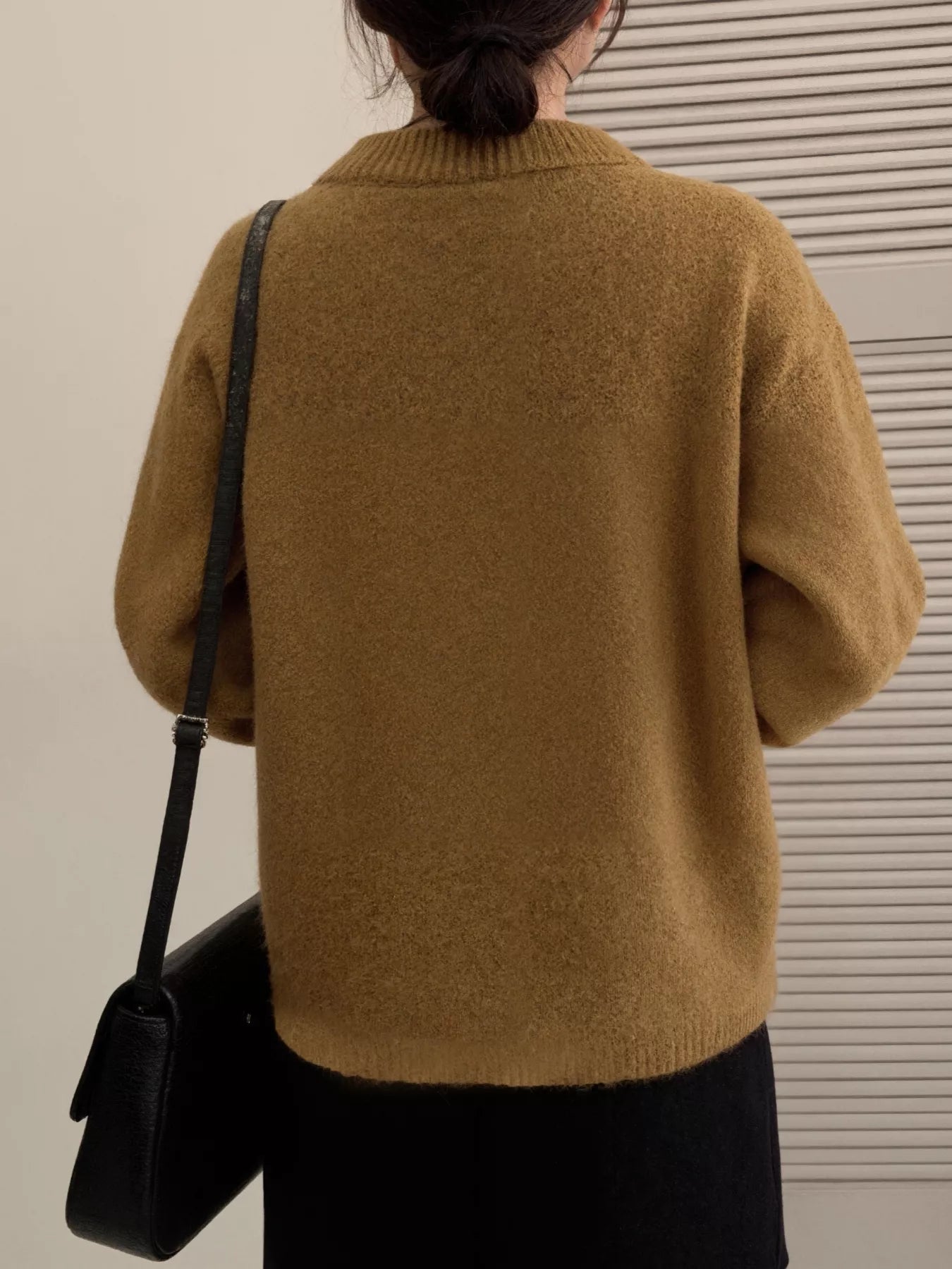 Back view of a woman wearing a brown knit cardigan, showcasing the cozy style and relaxed fit of the Lace Bowknot Knit Cardigan.