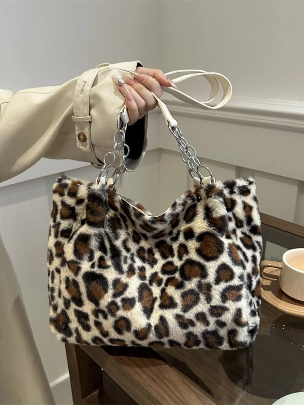 Faux Fur Leopard Shoulder Bag held by a person, showcasing its stylish design and large size.