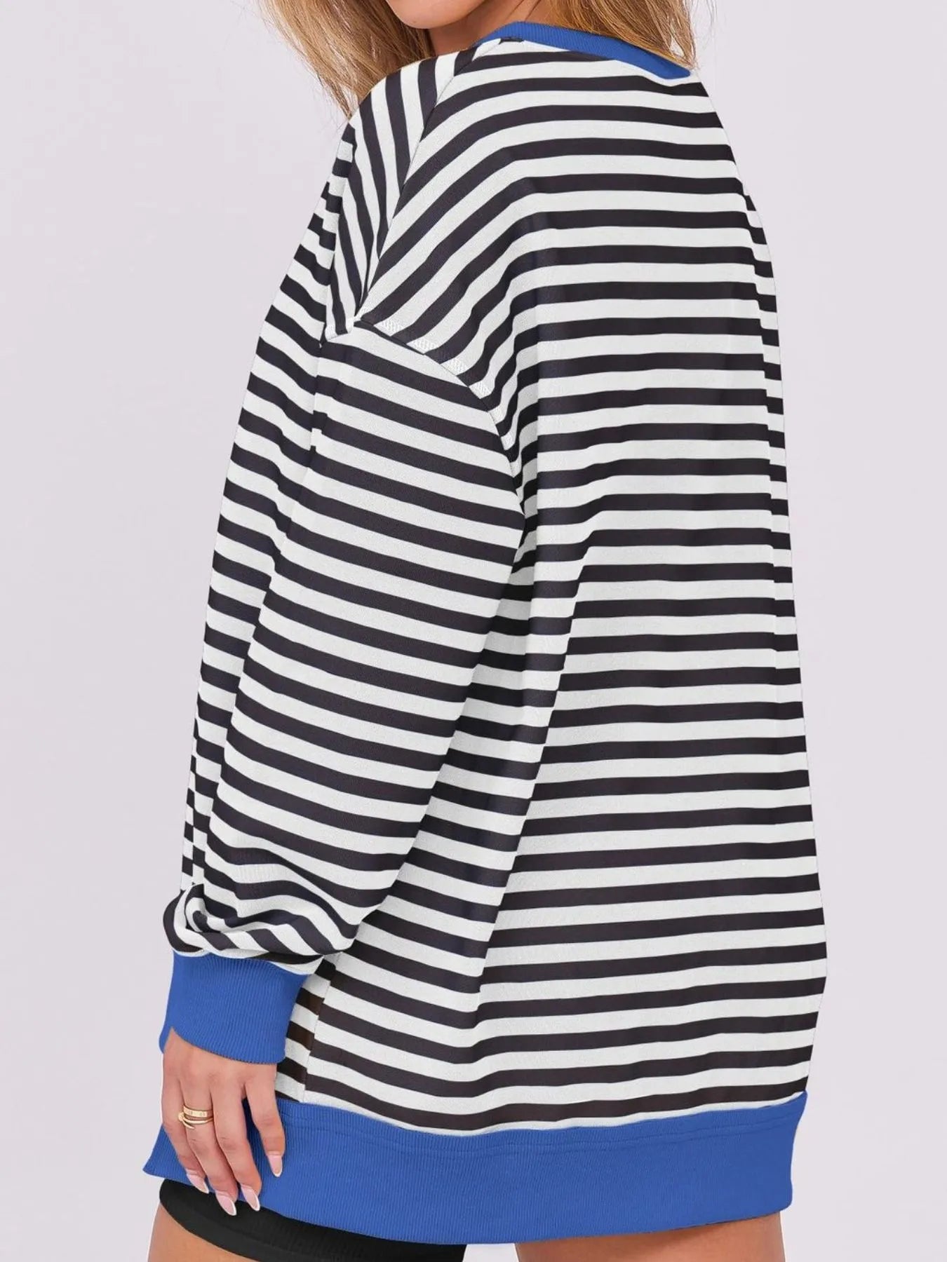 Model wearing a Notched Long Sleeve Oversized Sweatshirt with black and white stripes and blue accents for casual wear.