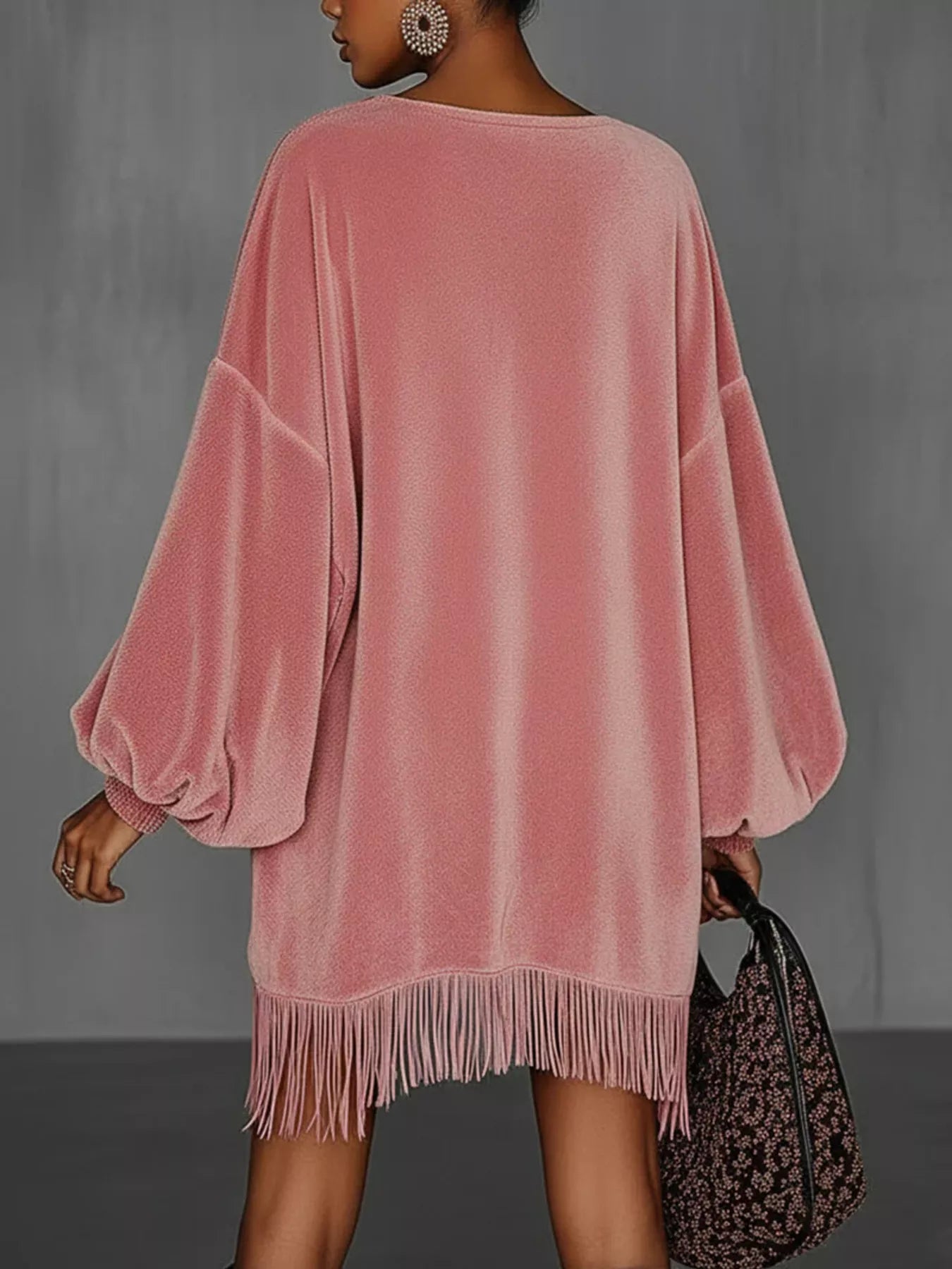 Model showcasing the Velvet Fringe Hem Mini Dress in pink, featuring a relaxed fit and stylish fringe detailing.