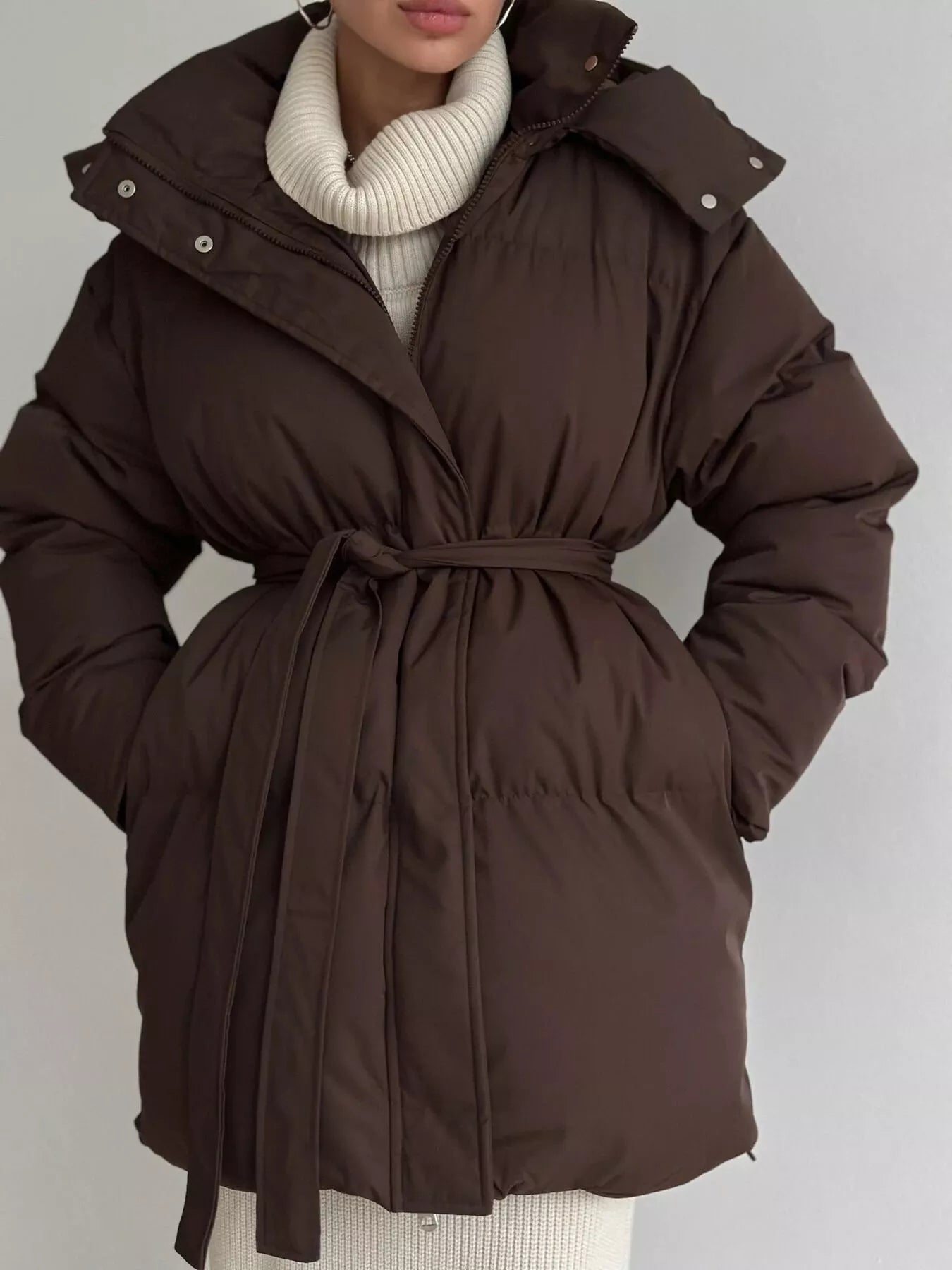 Mid Length Hooded Winter Coat Belted warm women jacket with pockets and zipper, styled in brown color.