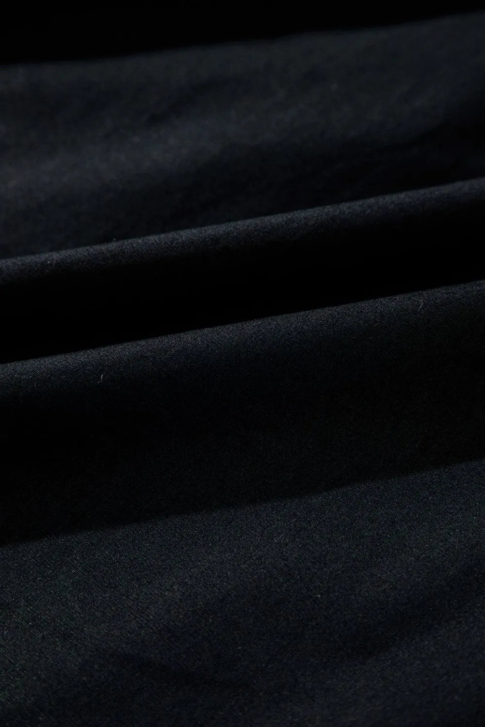 Close-up view of the 100% cotton fabric used in the V Neck Ruffled Cap Sleeve Smocked Maxi Dress.