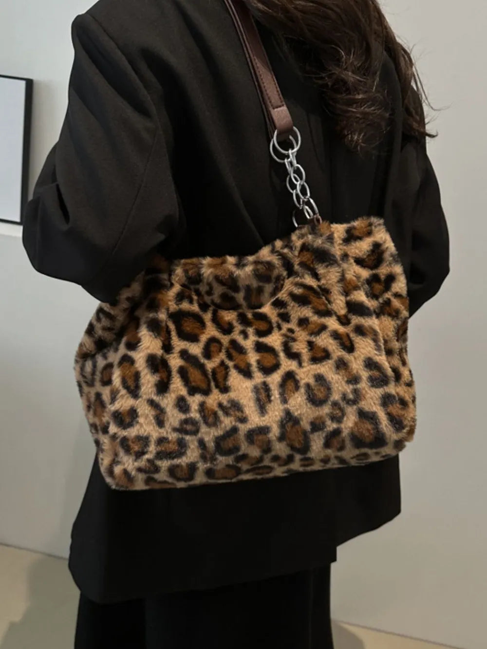Faux Fur Leopard Shoulder Bag displayed on a person, showcasing its bold leopard print and stylish shoulder design.