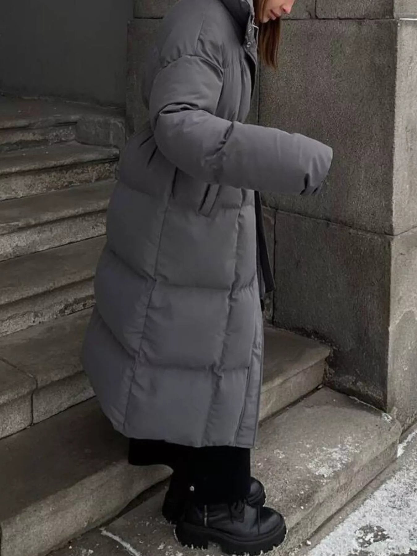 Longline Padded Winter Coat Belted warm women jacket featuring pockets and zipper, styled with chunky boots.