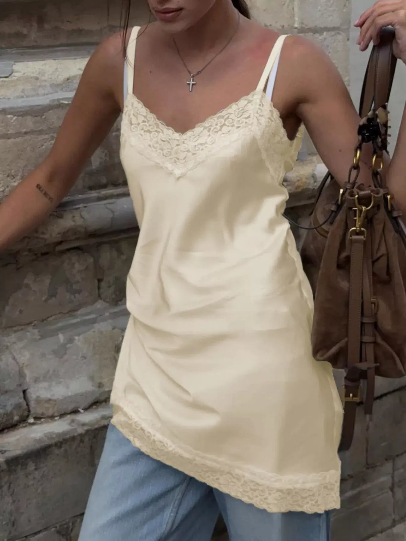 Lace Detail V-Neck Cami styled with jeans and a handbag, showcasing its elegant lace trim and feminine look.