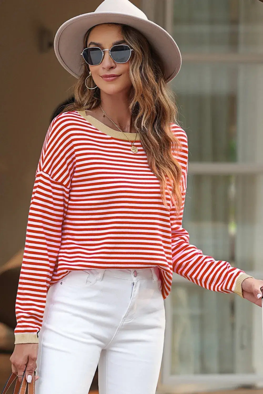 Striped Round Neck Drop Shoulder T-Shirt on a model, styled with white jeans and a hat for a casual look.