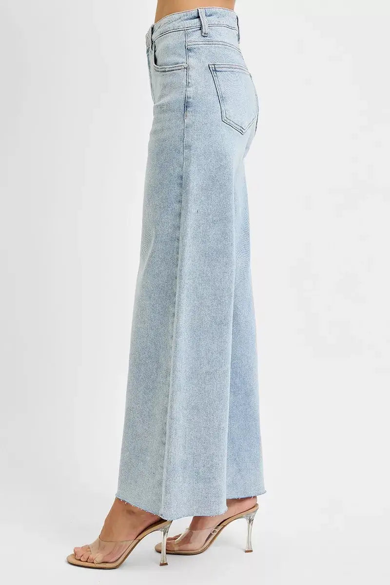 Side view of RISEN Full Size High Rise Ankle Wide Palazzo Jeans in light blue denim, showcasing the wide leg and ankle crop.