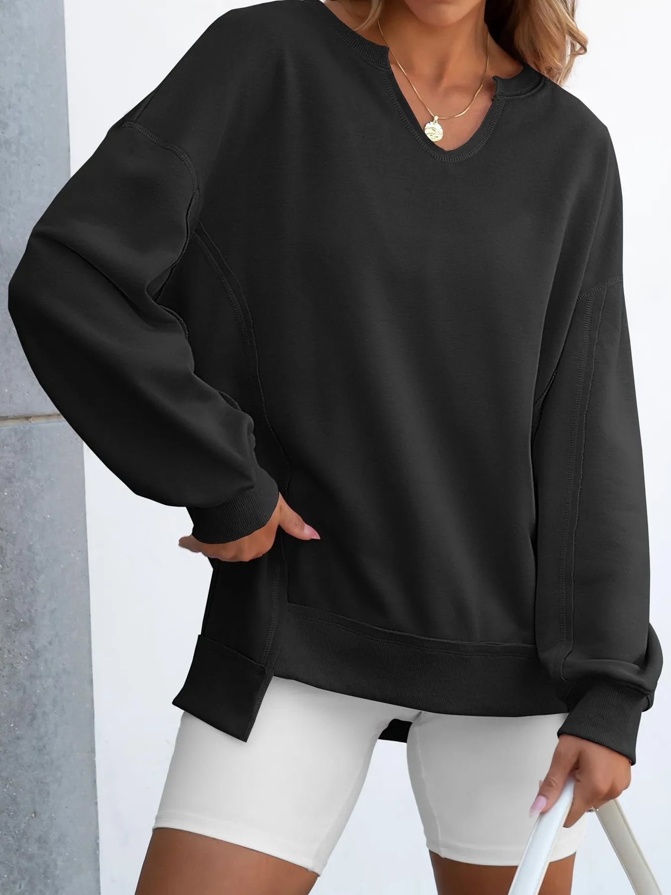 Notched Long Sleeve Oversized Sweatshirt in black, featuring contrast stitching and a relaxed fit for casual wear.