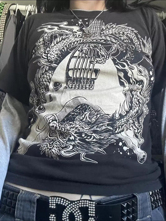 Close-up of a graphic black t-shirt featuring intricate dragon and guitar designs, perfect for casual wear.