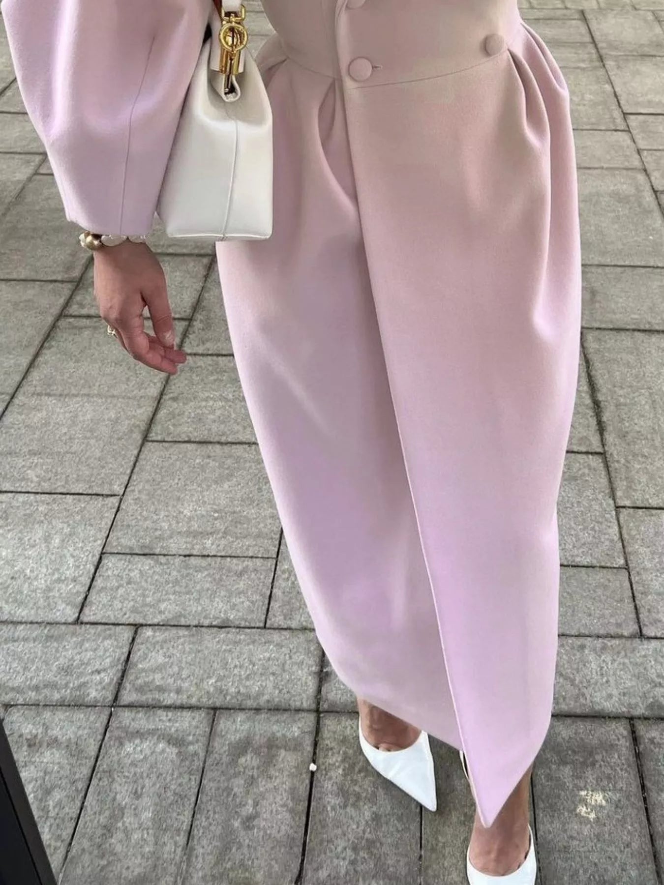 Double-Breasted Longline Coat showcased with elegant tailored silhouette and stylish accessories.