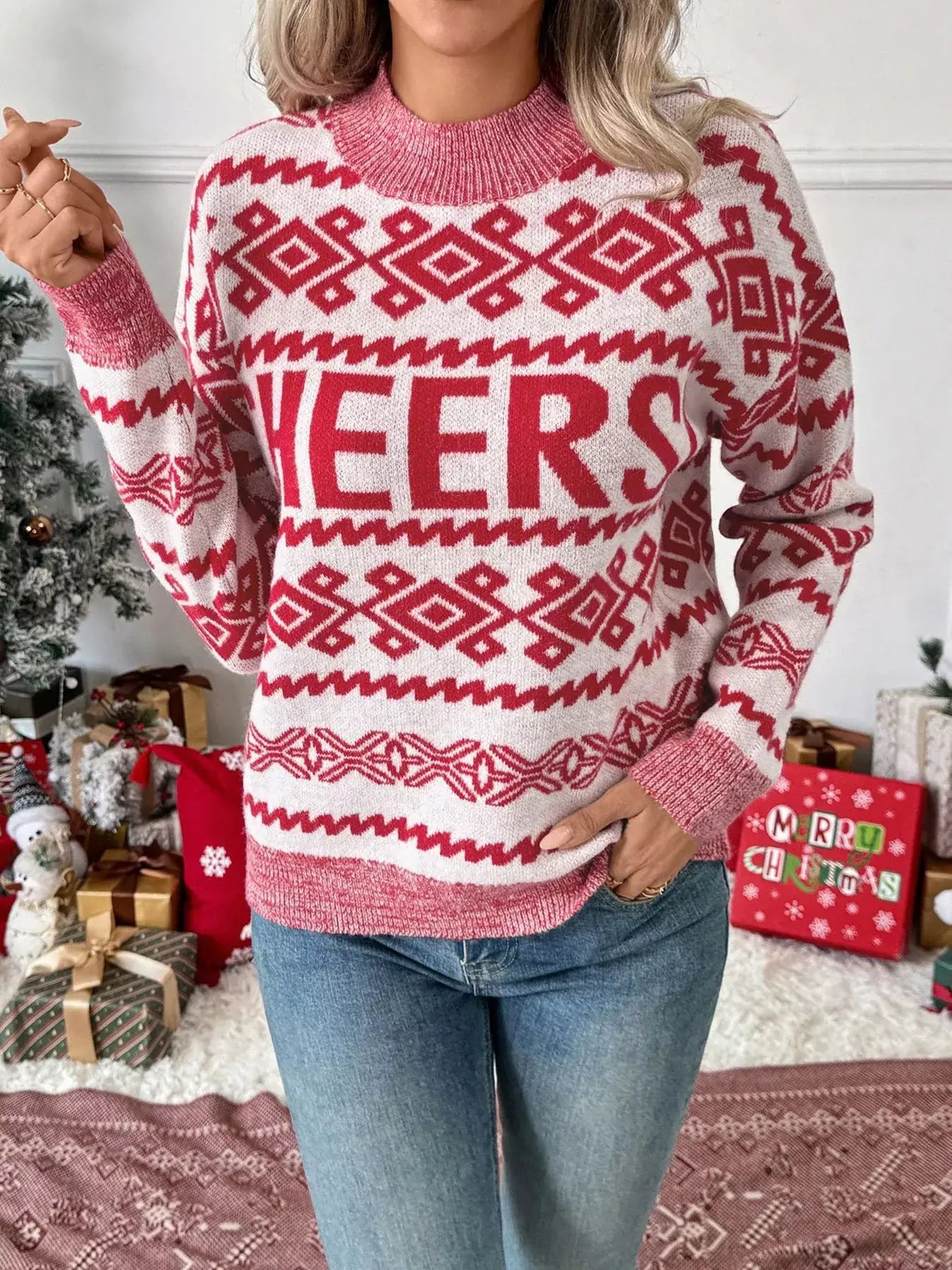 CHEERS Christmas Round Neck Long Sleeve Sweater worn by a model in front of festive decorations.