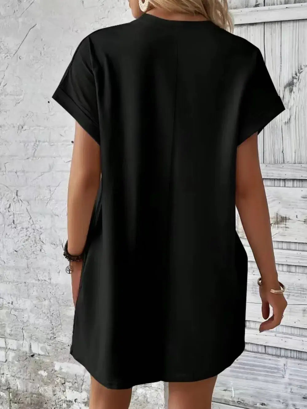 Back view of a Pocketed Round Neck Short Sleeve Dress in black, showcasing the casual and comfortable style.