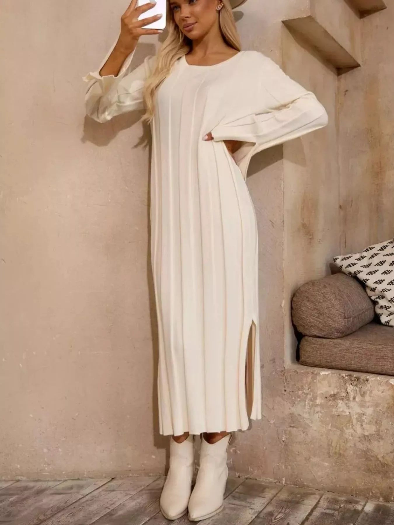 Model wearing a Ribbed Knit Slit Sweater Dress in white with a side slit, showcasing its elegant design.