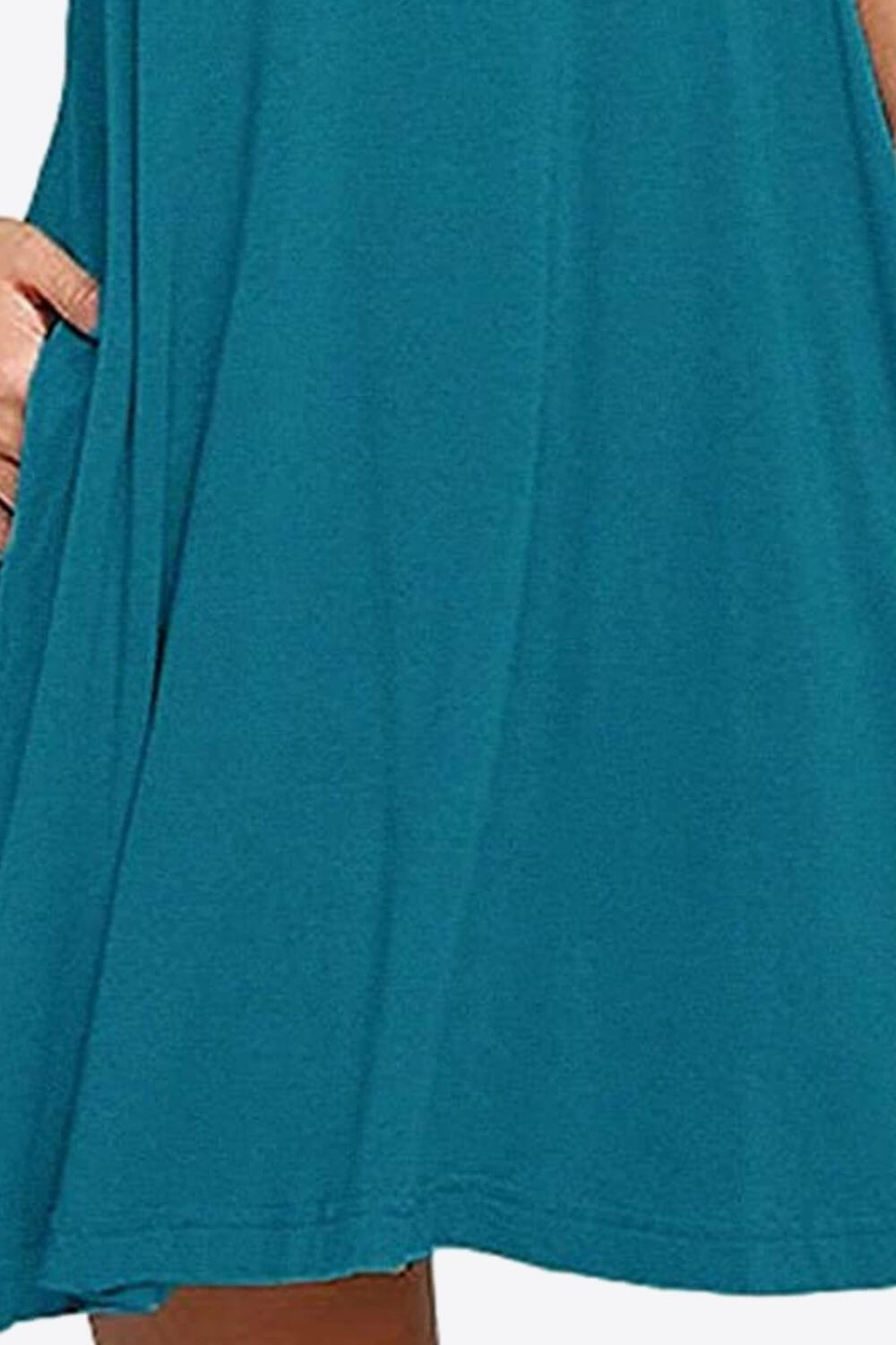 Close-up of a teal sleeveless dress with side pockets, showcasing its casual style and soft fabric.