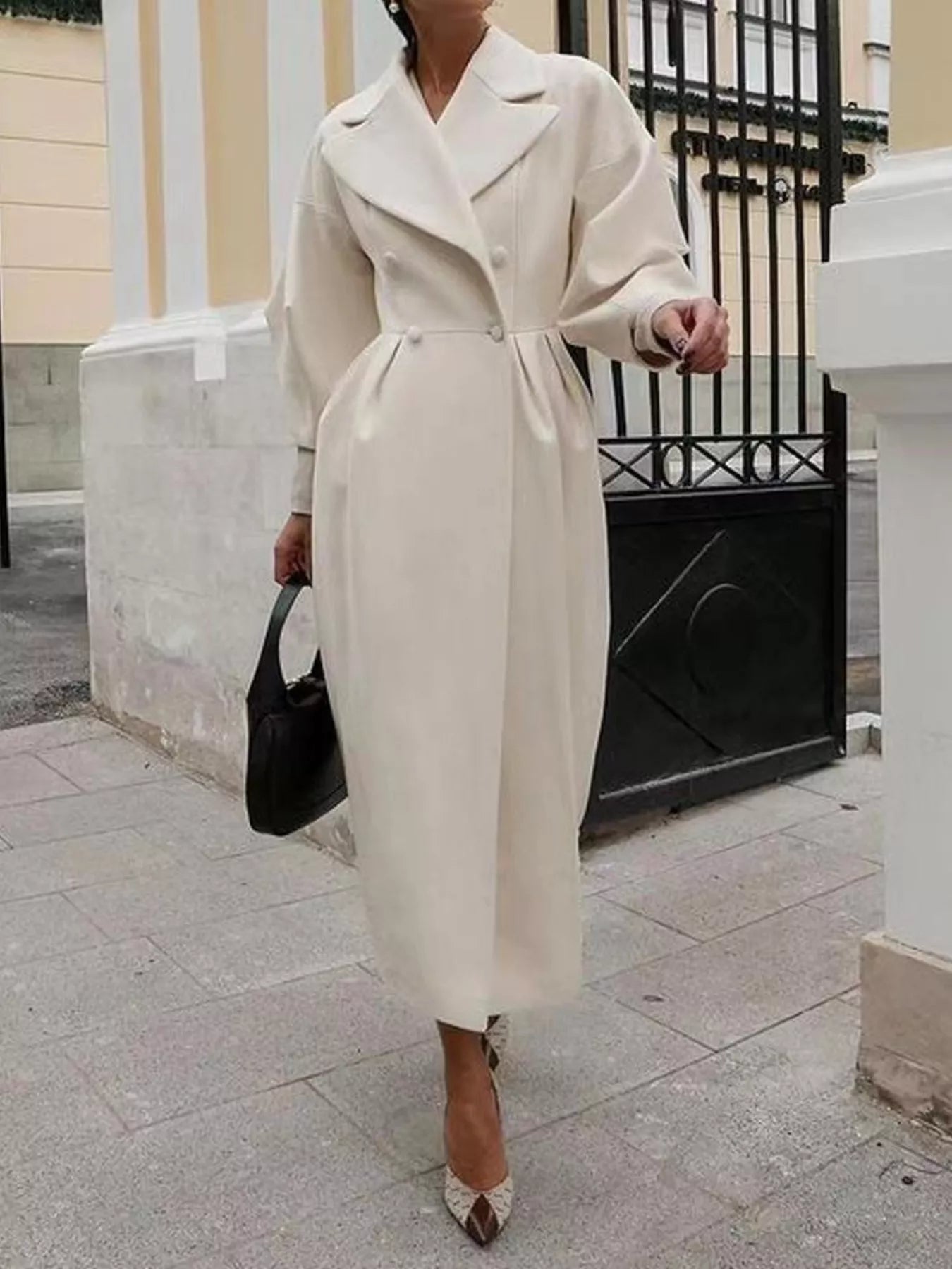Double-Breasted Longline Coat in cream color, featuring a tailored silhouette with buttoned design and ruched sleeves.