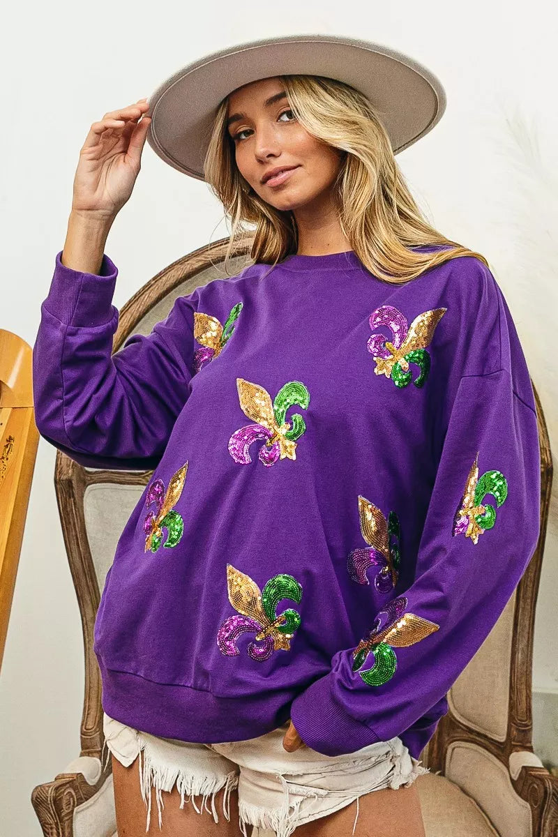 BiBi Fleur De Lis Sequin Patches Mardi Gras Sweatshirt on model with sequin patches, purple sweatshirt, festive style.