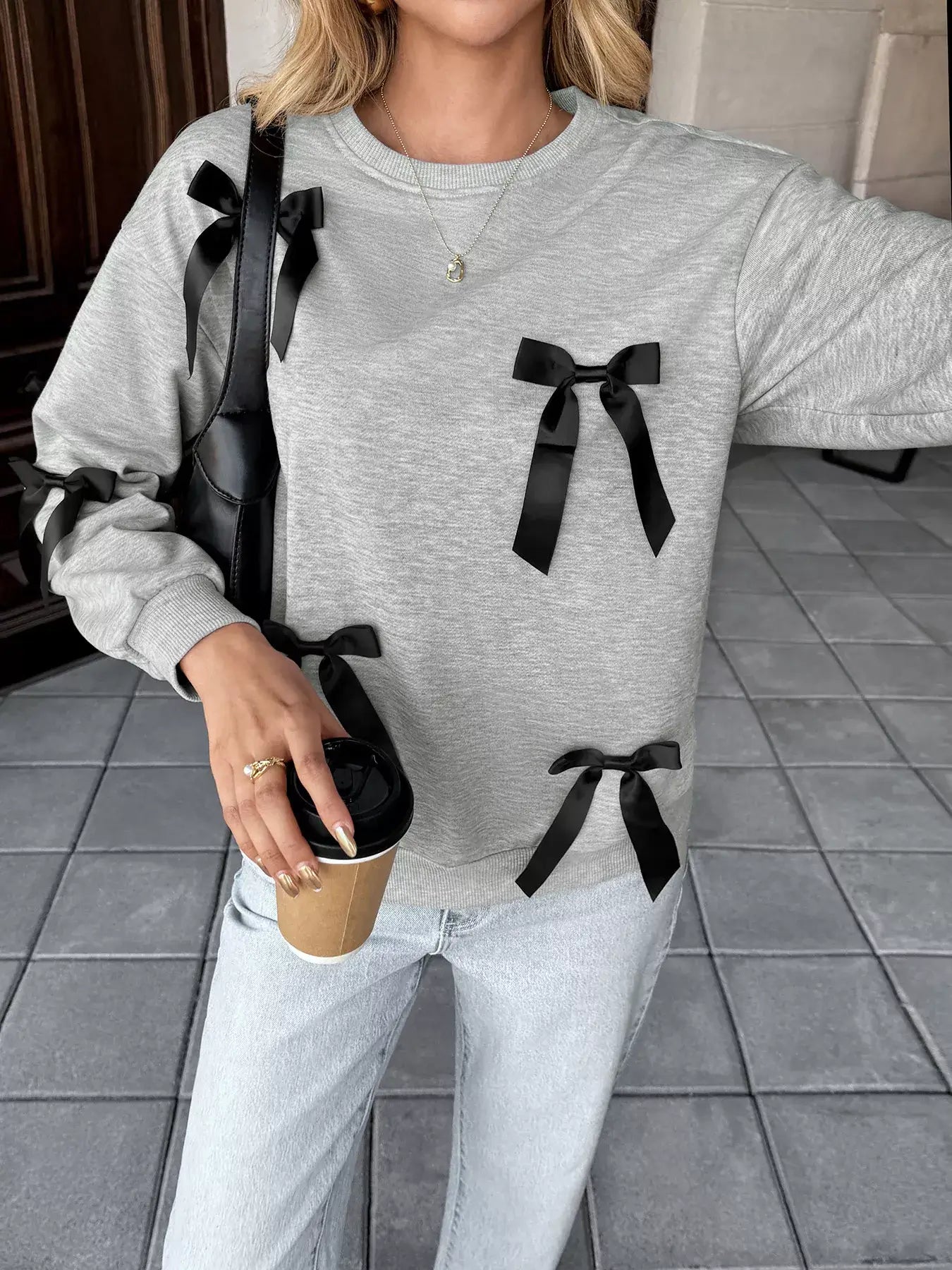 Bow Detail Round Neck Sweatshirt featuring black bow accents with a casual and stylish look.