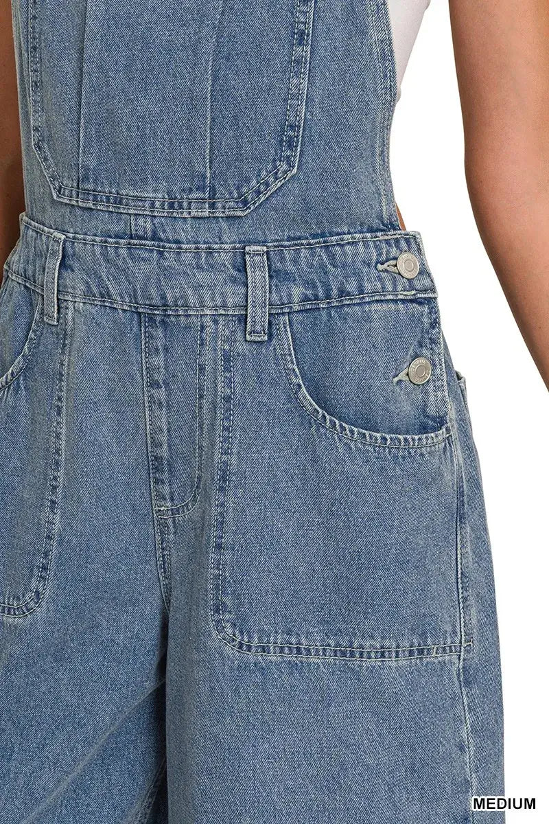 Close-up of Zenana Denim Wide Leg Overalls in medium wash, featuring pockets and a relaxed fit design.