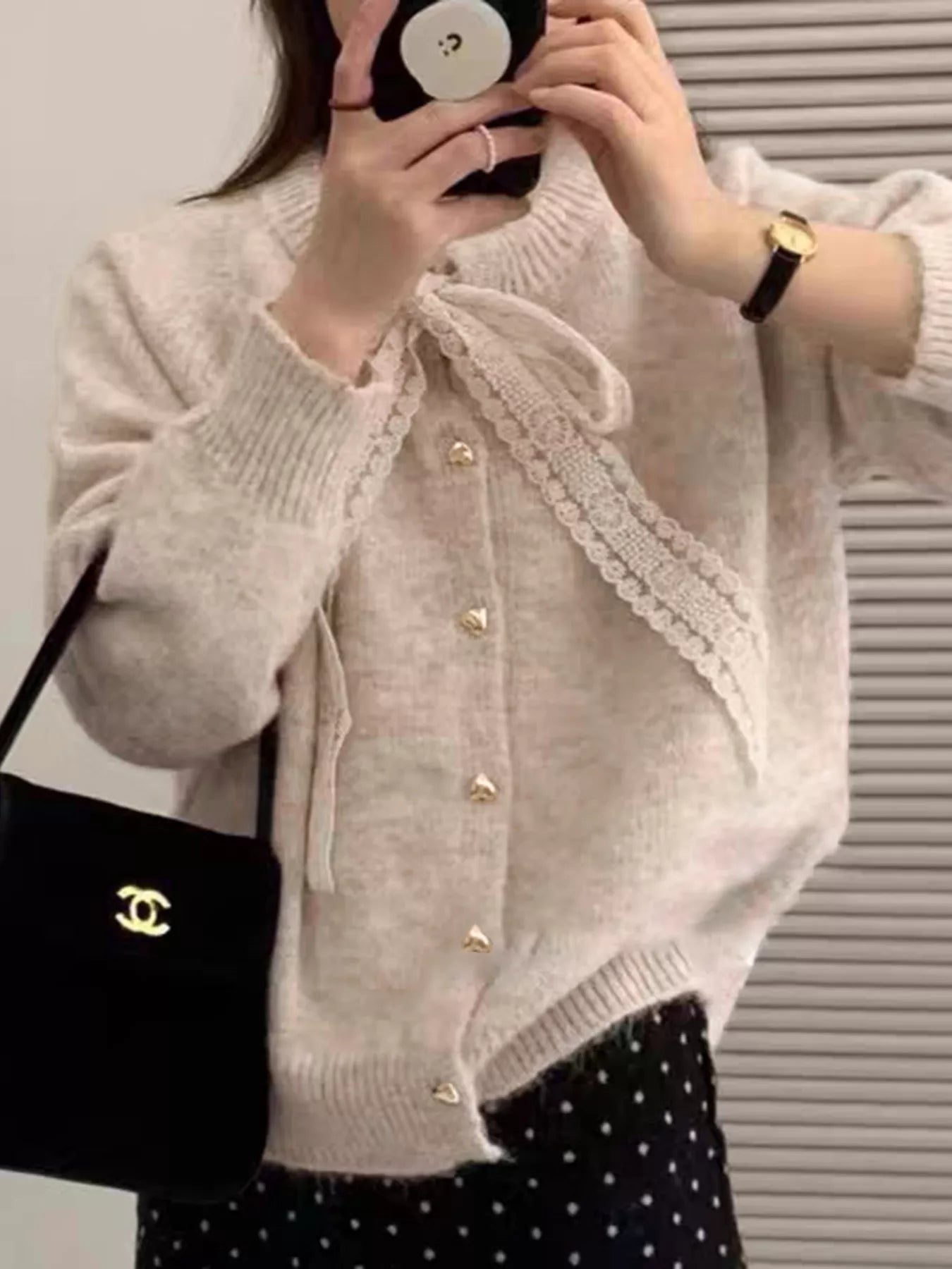 Lace Bowknot Knit Cardigan displayed by a woman, featuring buttons and a delicate lace bow detail.