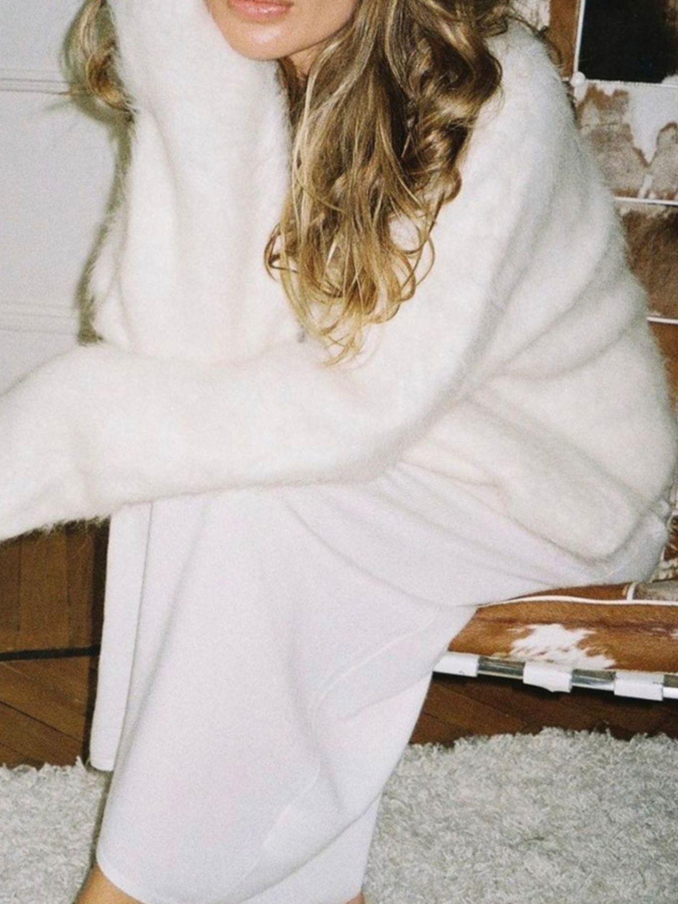 Fuzzy Round Neck Long Sleeve Sweater cozy women's pullover in soft white fabric, styled with a light skirt.