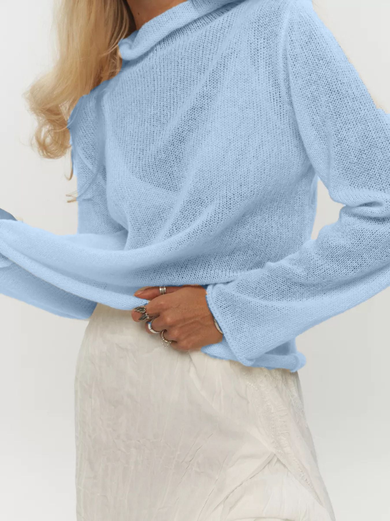 Mock Neck Long Sleeve Sweater in soft blue, featuring a relaxed fit and long sleeves, paired with a light skirt.