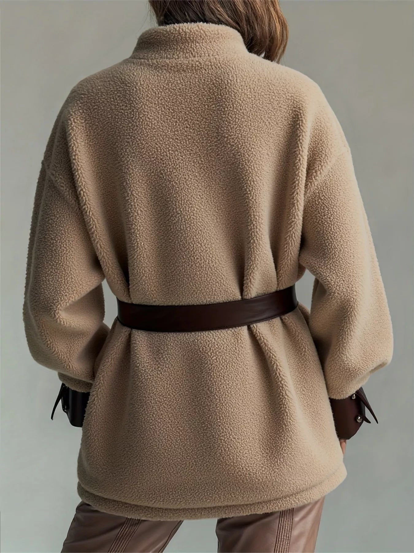 Leather Trim Sherpa Outerwear with Pockets, featuring a belted design in a cozy beige fabric.