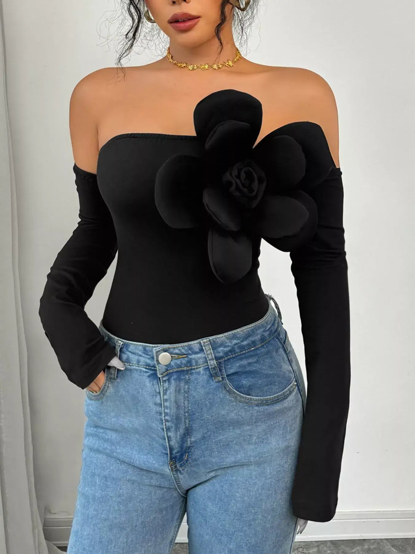 Flower Off-Shoulder Long Sleeve Bodysuit – Elegant Stretch Fit with floral detail, worn with high-waisted jeans.
