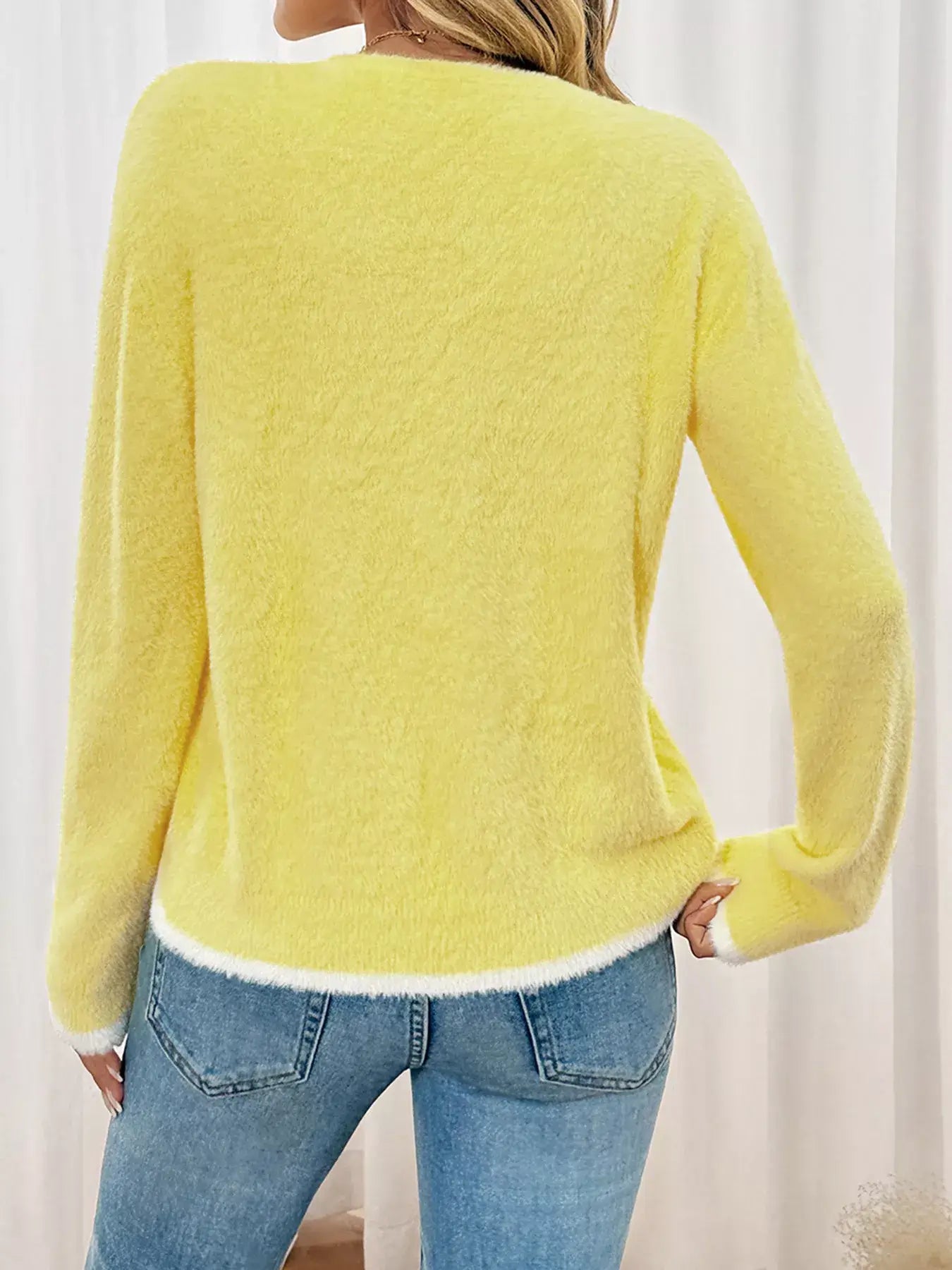Back view of a model wearing a Lace Bow-Tie Front Long Sleeve Cardigan in yellow with light blue jeans.