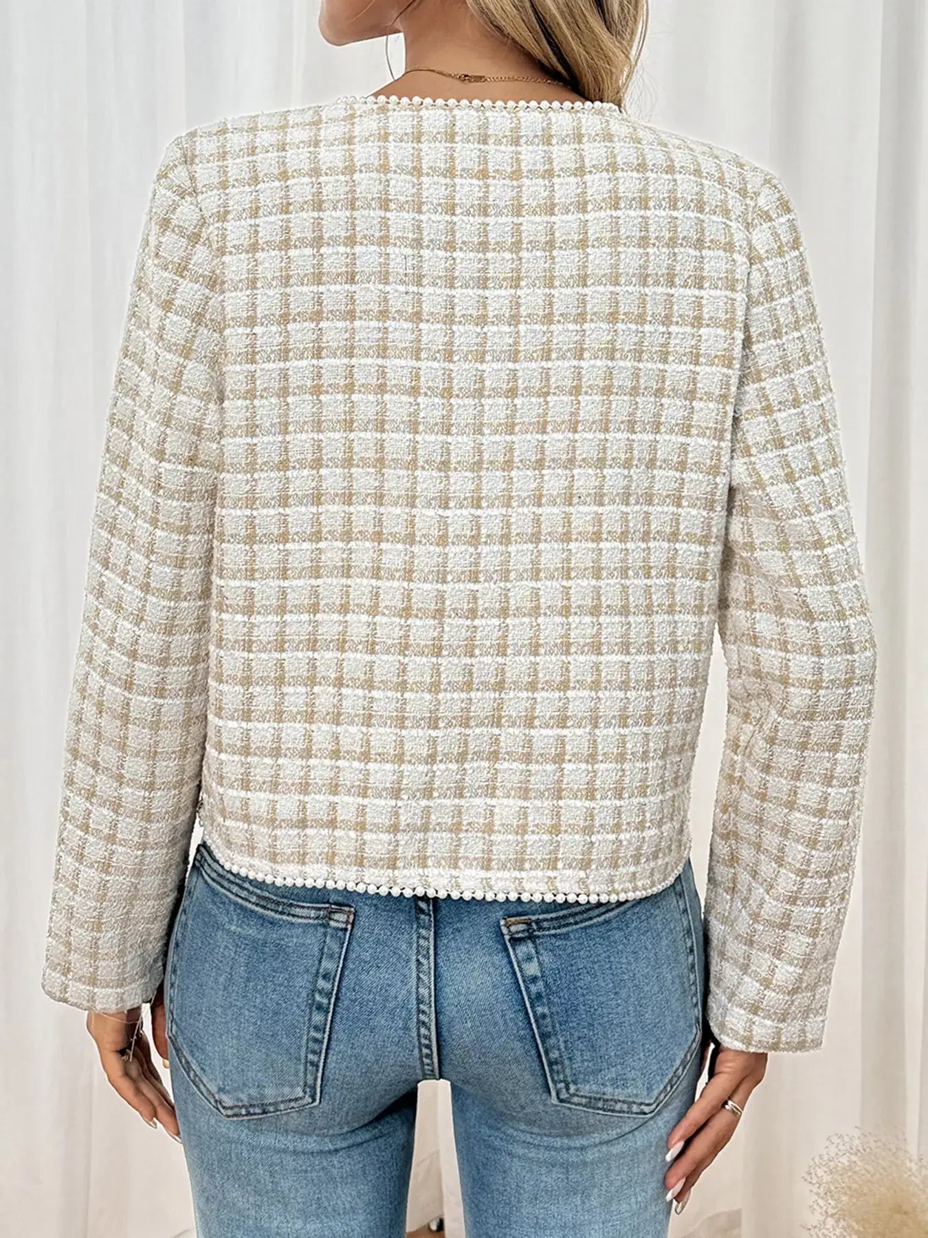 Woman wearing plaid button-front long sleeve outerwear, showcasing the classic patterned back design.