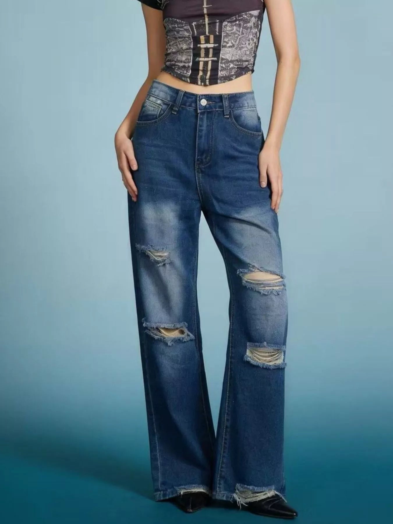 Distressed Wide Leg Jeans with buttoned pockets and a trendy design, featuring stylish rips and a relaxed fit.