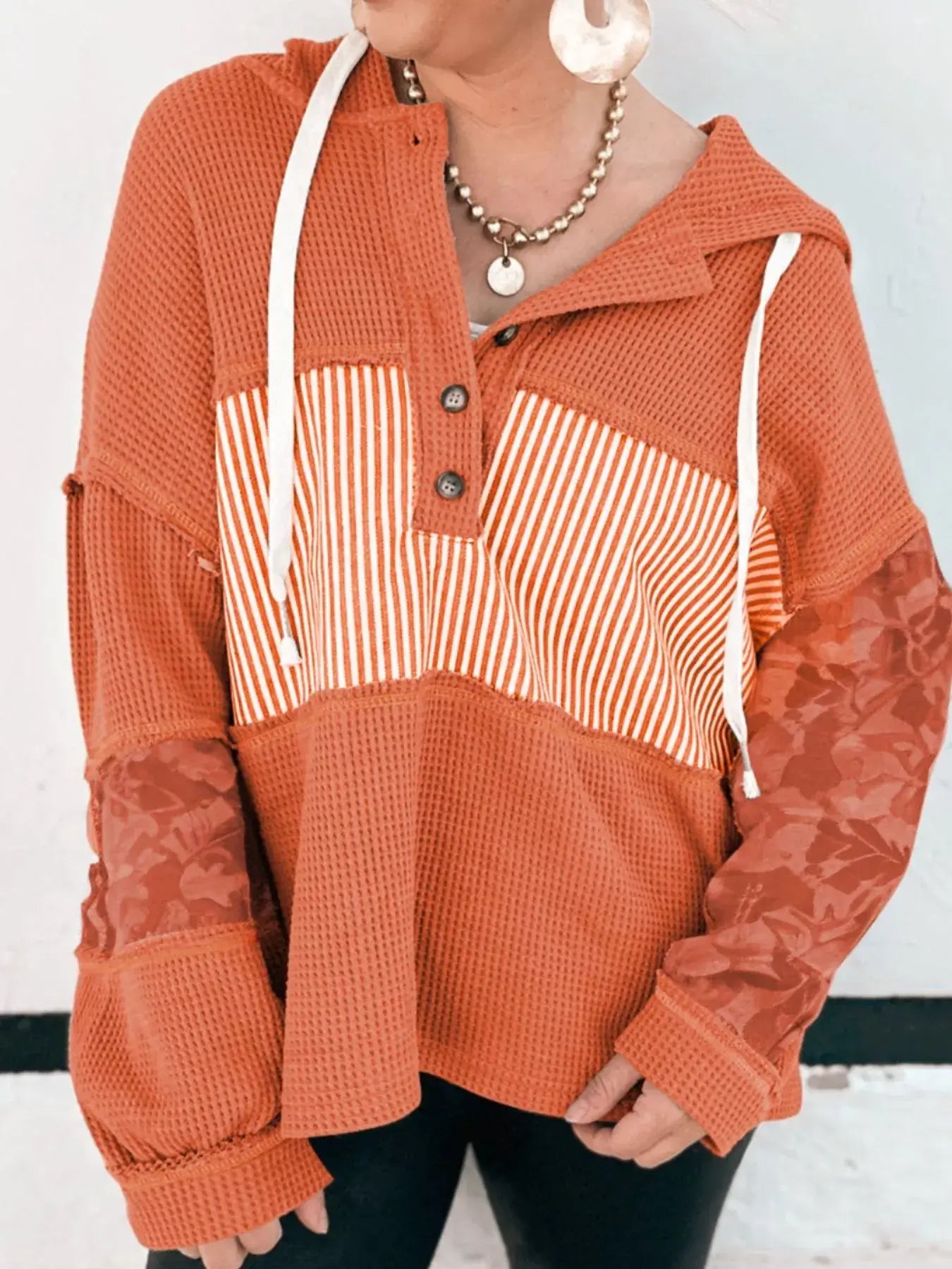 Waffle Knit Color Block Striped Drawstring Hoodie in orange with buttoned neckline and stylish color block design.