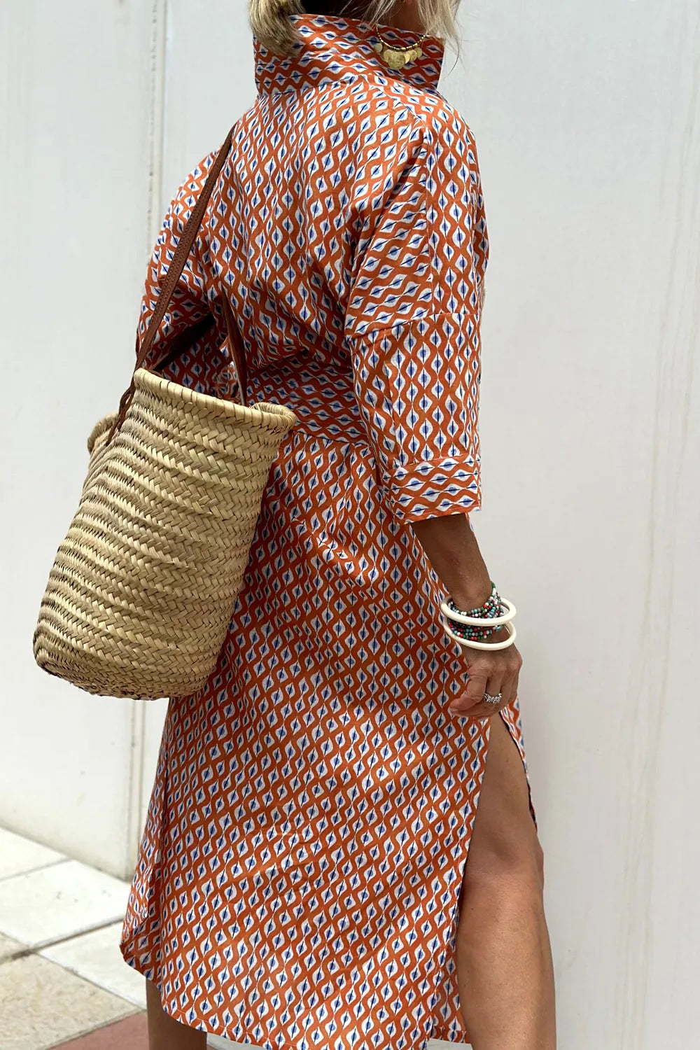 Tied Button Up Three-Quarter Sleeve Dress for Women with stylish open side, paired with a straw bag.
