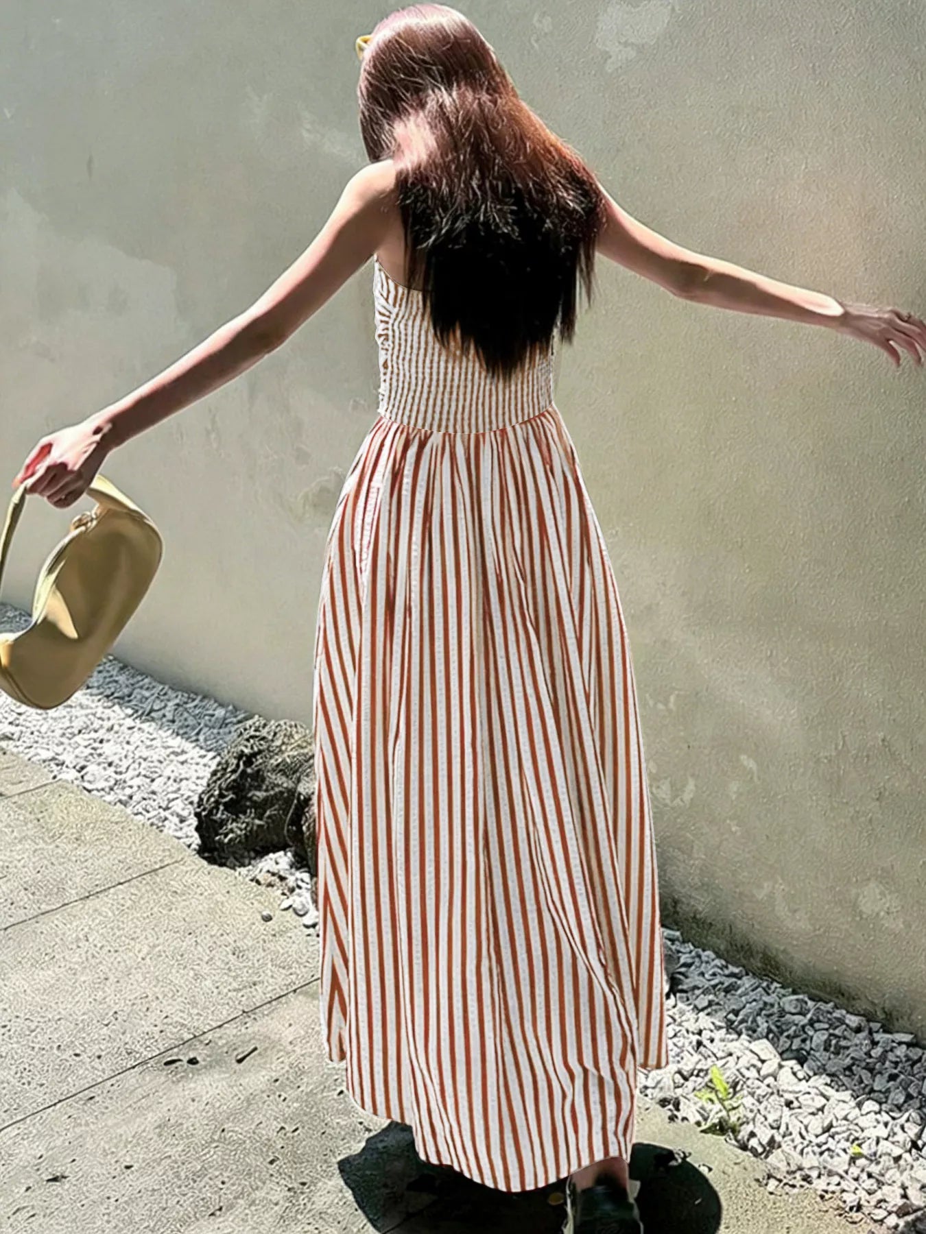 Striped Spaghetti Strap Casual Maxi Dress seen from the back, showcasing its long silhouette and striped pattern for summer wear.