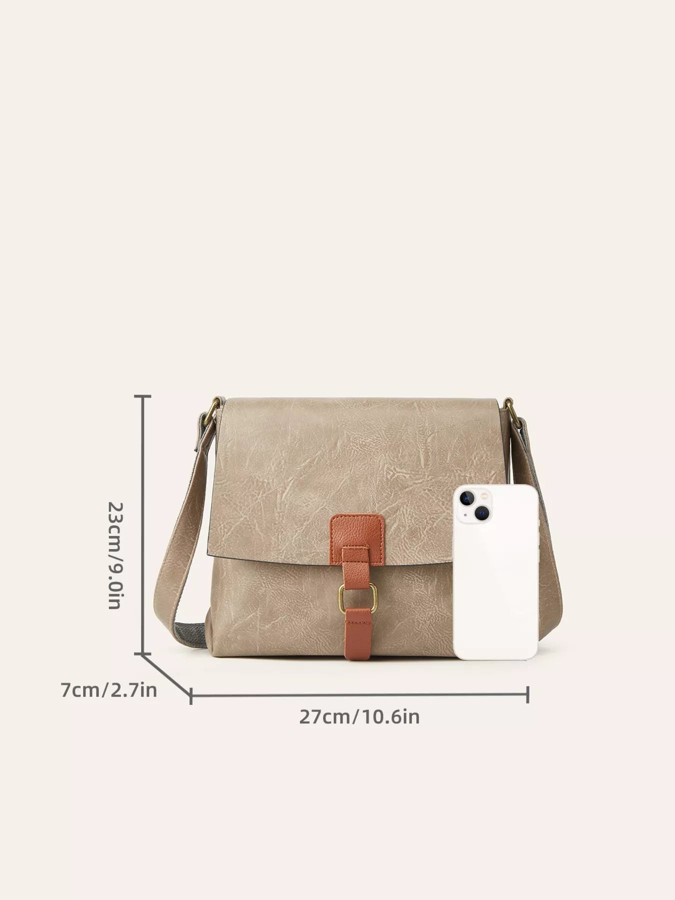 Vintage Buckle Flap Crossbody Bag displayed with size measurements and a phone for scale, showcasing its medium size and retro design.
