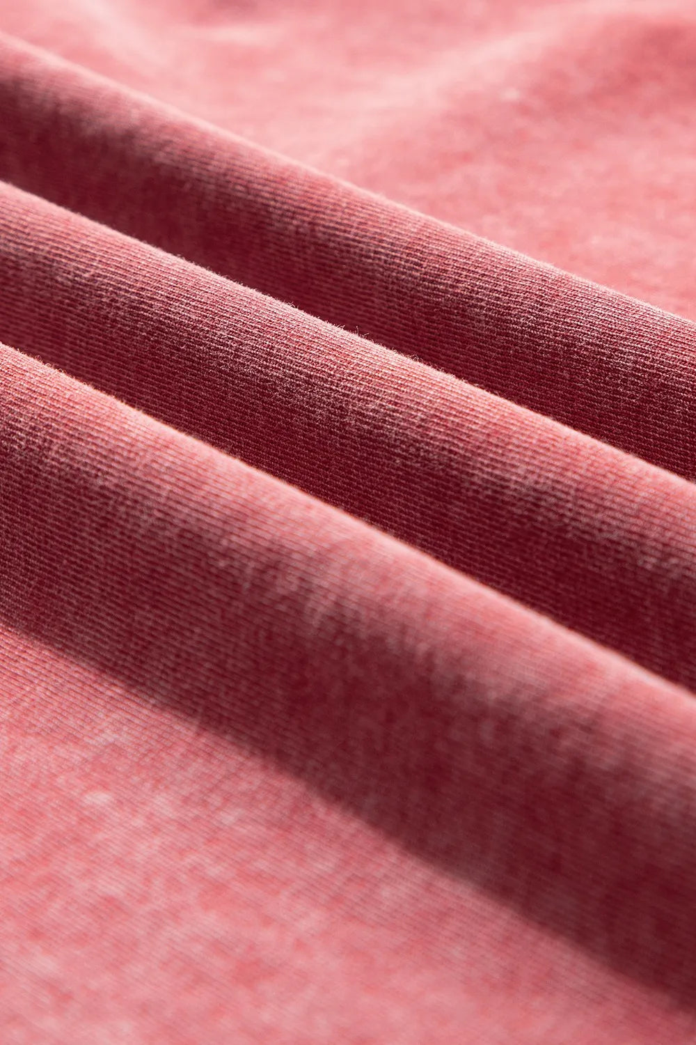 Close-up of slightly stretchy cotton fabric in a soft rose color, ideal for One Shoulder Half Sleeve Oversized Tunic T Shirt.