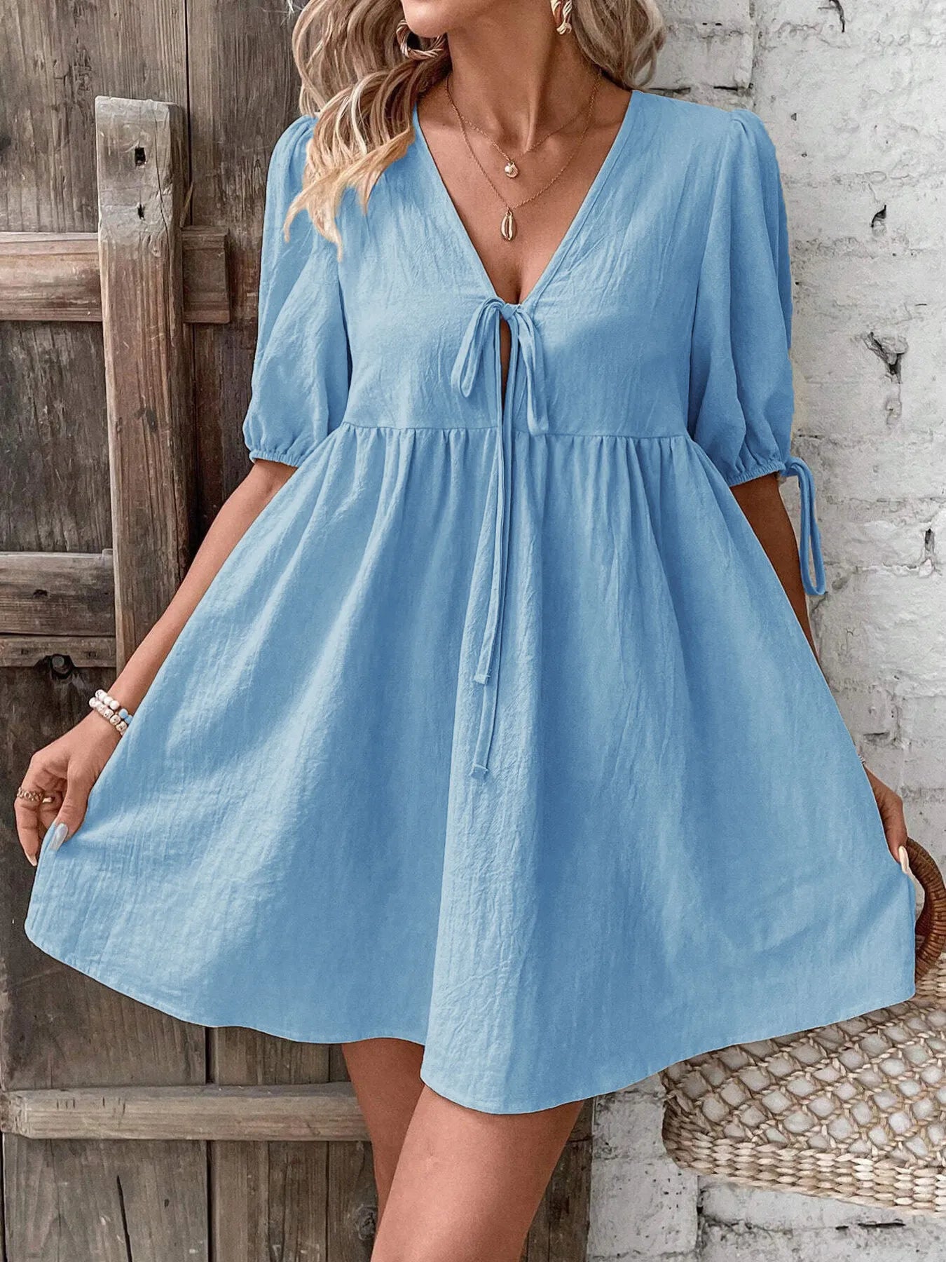 V-Neck Tie-Front Mini Dress with Puff Sleeves in light blue, showcasing a tied front detail and flowy skirt.