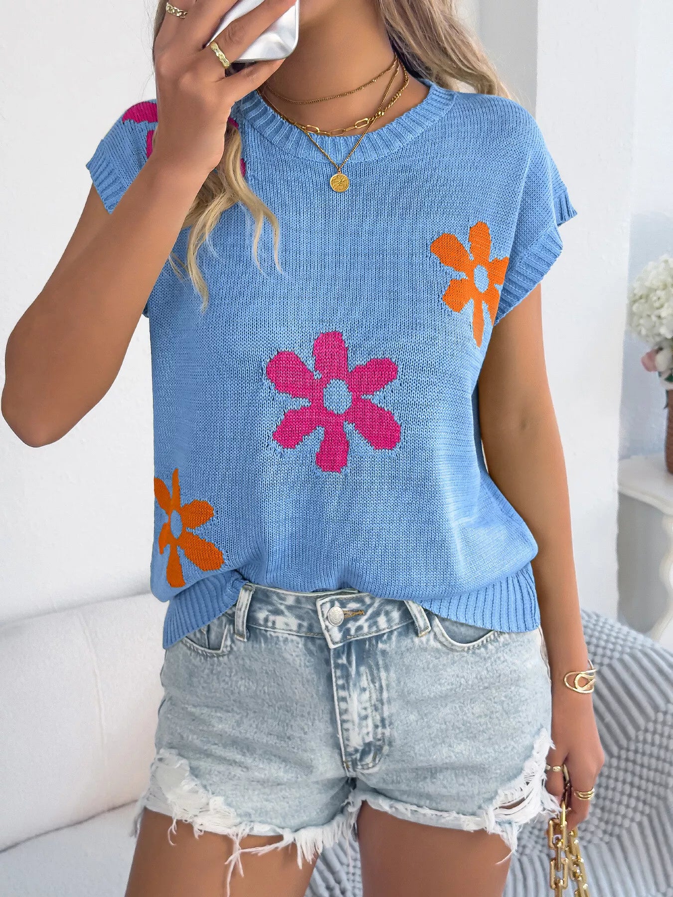 Flower Round Neck Sweater in blue with colorful floral design, paired with denim shorts for a stylish women's look.