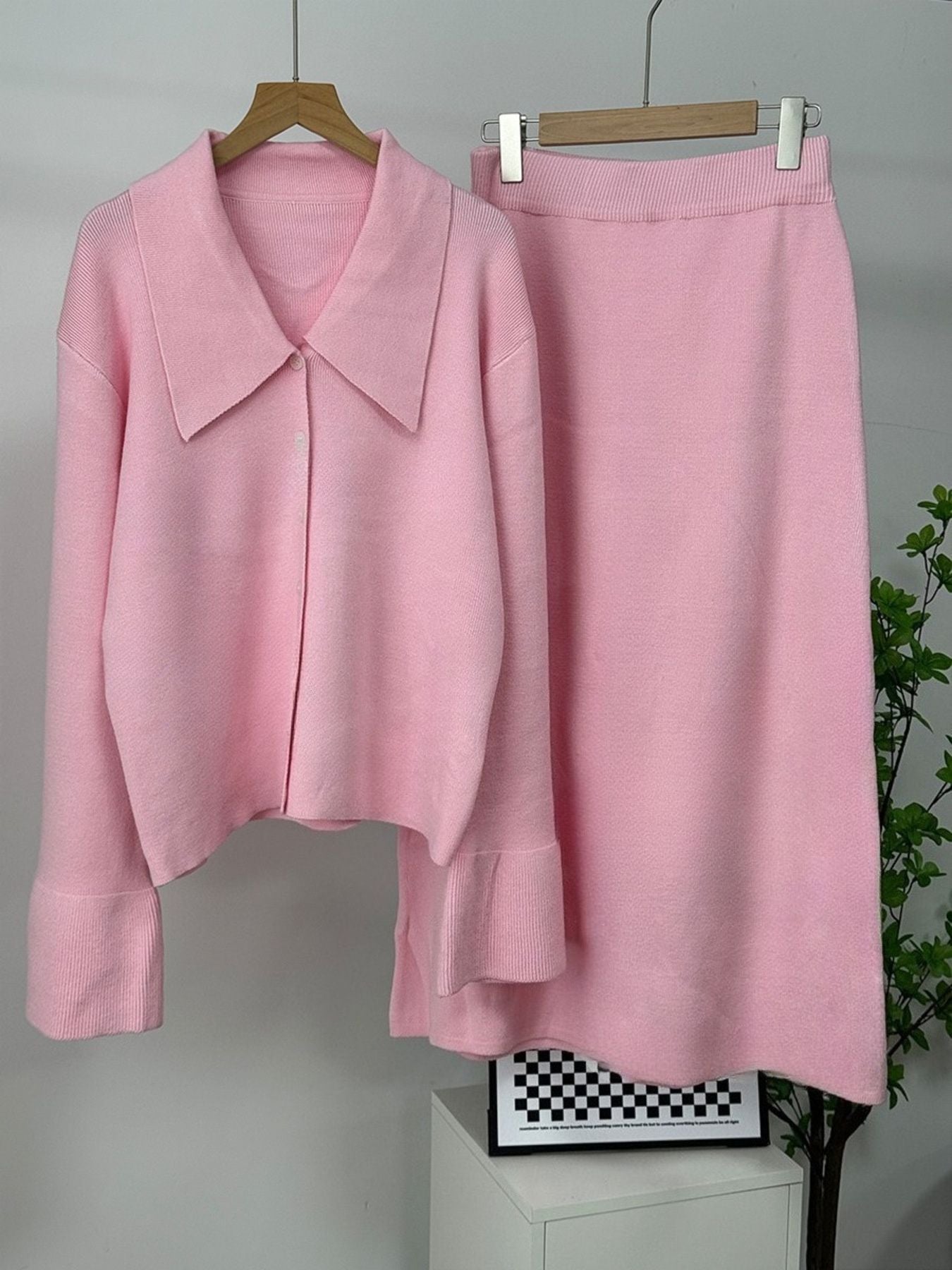 Button Down Cardigan and Skirt Knit Set in pink, featuring a ribbed buttoned cardigan and a matching skirt.