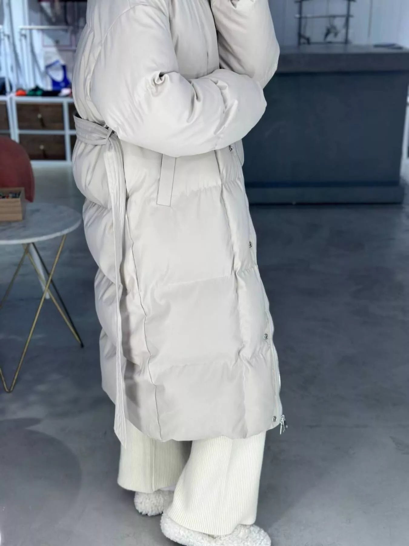 Longline Padded Winter Coat Belted warm women jacket in light beige color, featuring a zippered design and pockets.