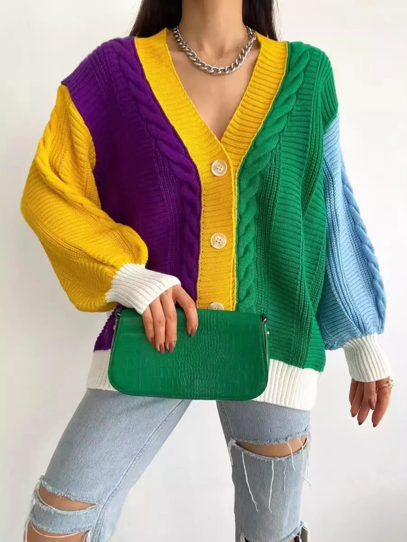 Color Block Button Down Cable-Knit Cardigan worn with a green handbag, showcasing vibrant colors and a cozy knit design.