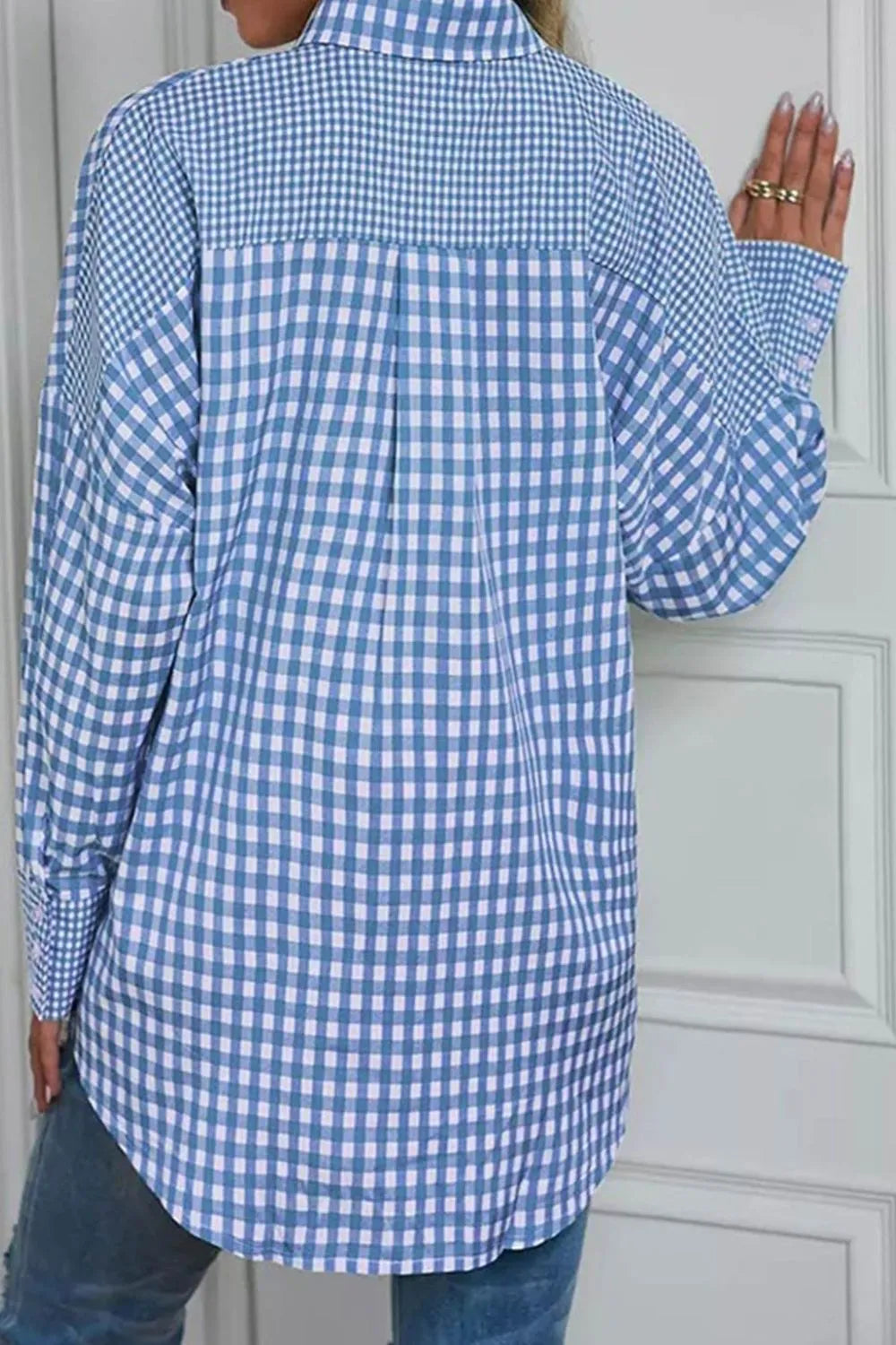 Back view of a woman wearing a blue and white checked Plaid Button Up Long Sleeve Shirt, showcasing its casual style.