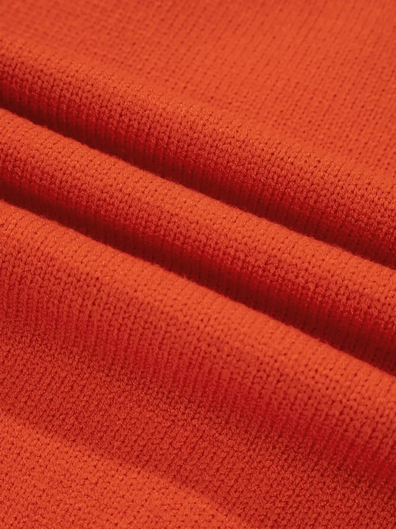 Collared V Neck Ribbed Edge Sweater fabric in vibrant orange texture showcasing its soft ribbed knit design.