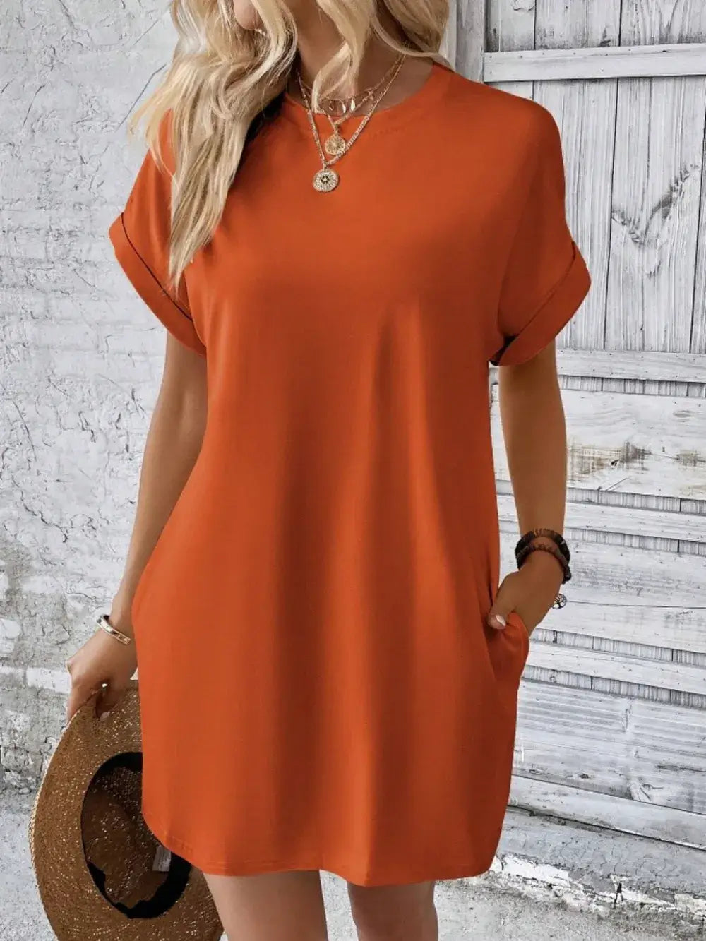 Pocketed round neck short sleeve dress in orange, featuring a relaxed fit and practical pockets for casual style.