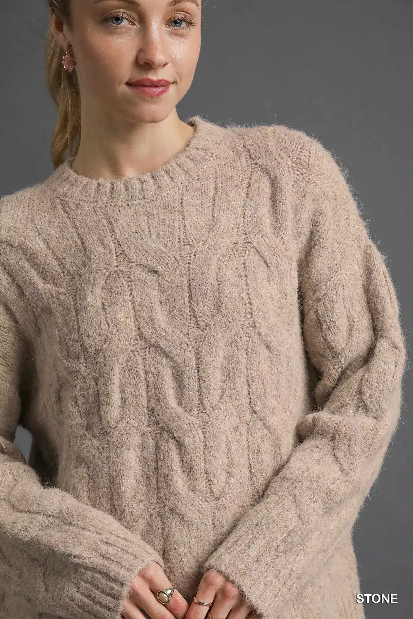 Umgee Cable Knit Cozy Sweater in soft beige, featuring an intricate cable knit design for a timeless winter style.