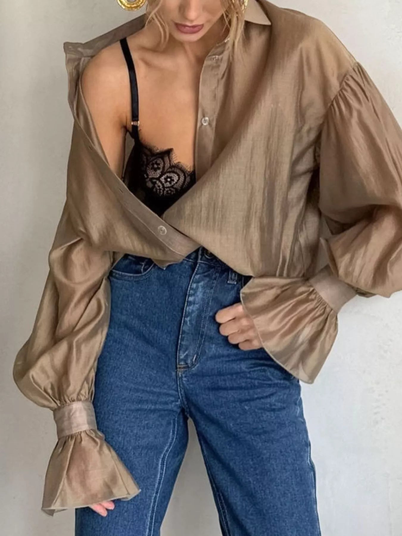 Model wearing a Button Up Flounce Sleeve Shirt styled with high-waisted jeans and a lace bralette for a chic look.